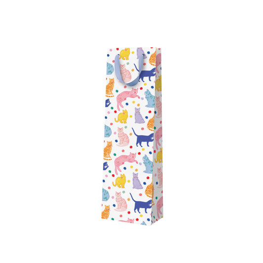 A white bottle sized gift bag with a blue ribbon handle and a colourful print featuring lots of unusually coloured cats - pink, blue, yellow 